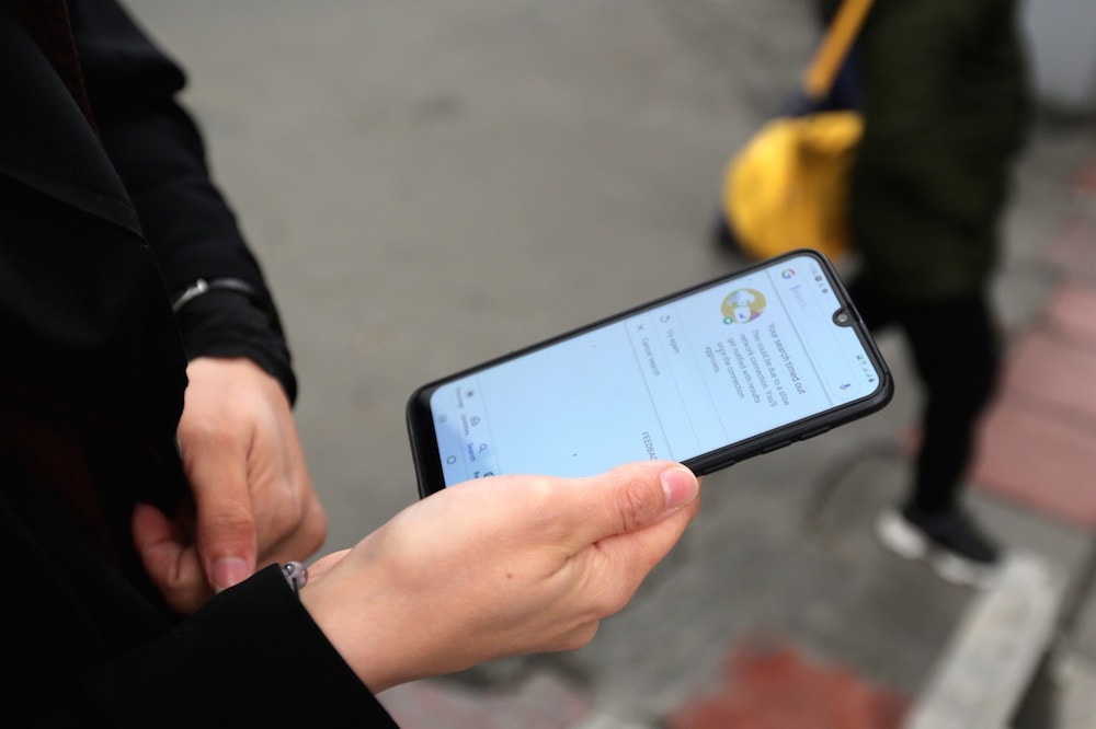 This image shows woman using mobile phone in Tehran.
